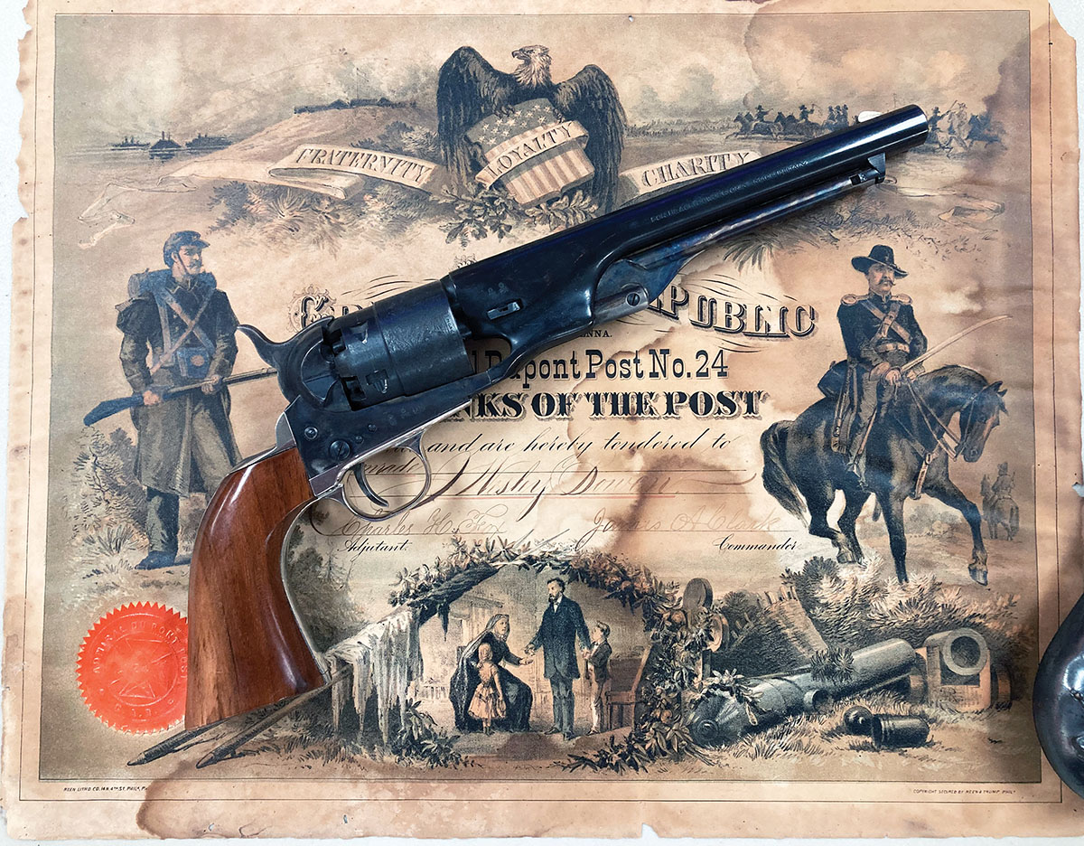 The author’s reproduction Colt 1860 Army pictured against a charter of the Great Army of the Republic. The government models were issued with a screw that could be used to install a carbine stock.